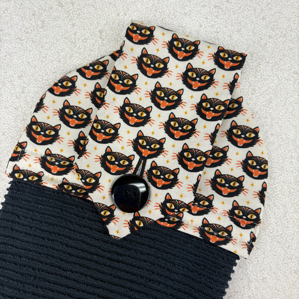 Black and orange cat on a light gray background kitchen towel