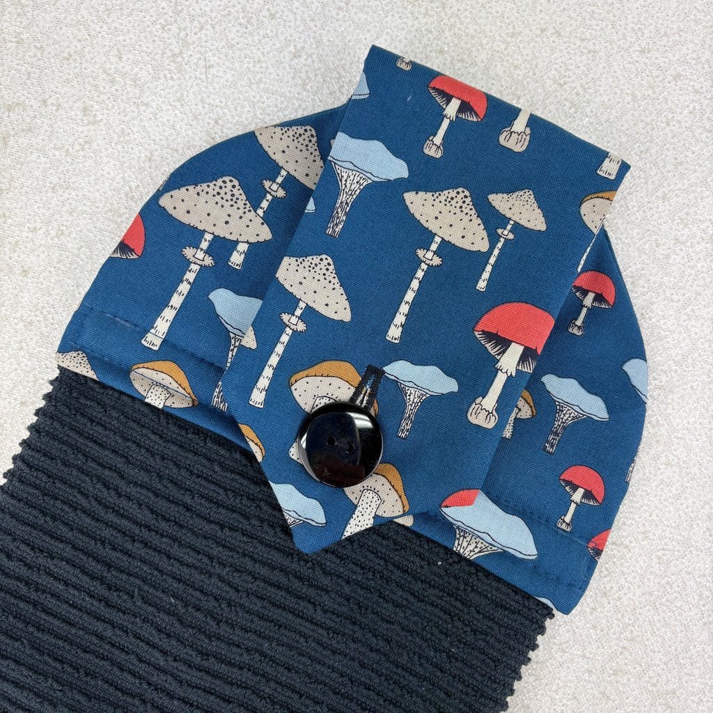 Blue fabric with mushroom pattern on a textured surface kitchen towel