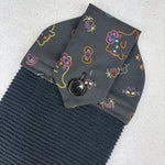 Load image into Gallery viewer, Dark gray fabric with colorful cat face patterns and a button on a light gray background, halloween, spooky
