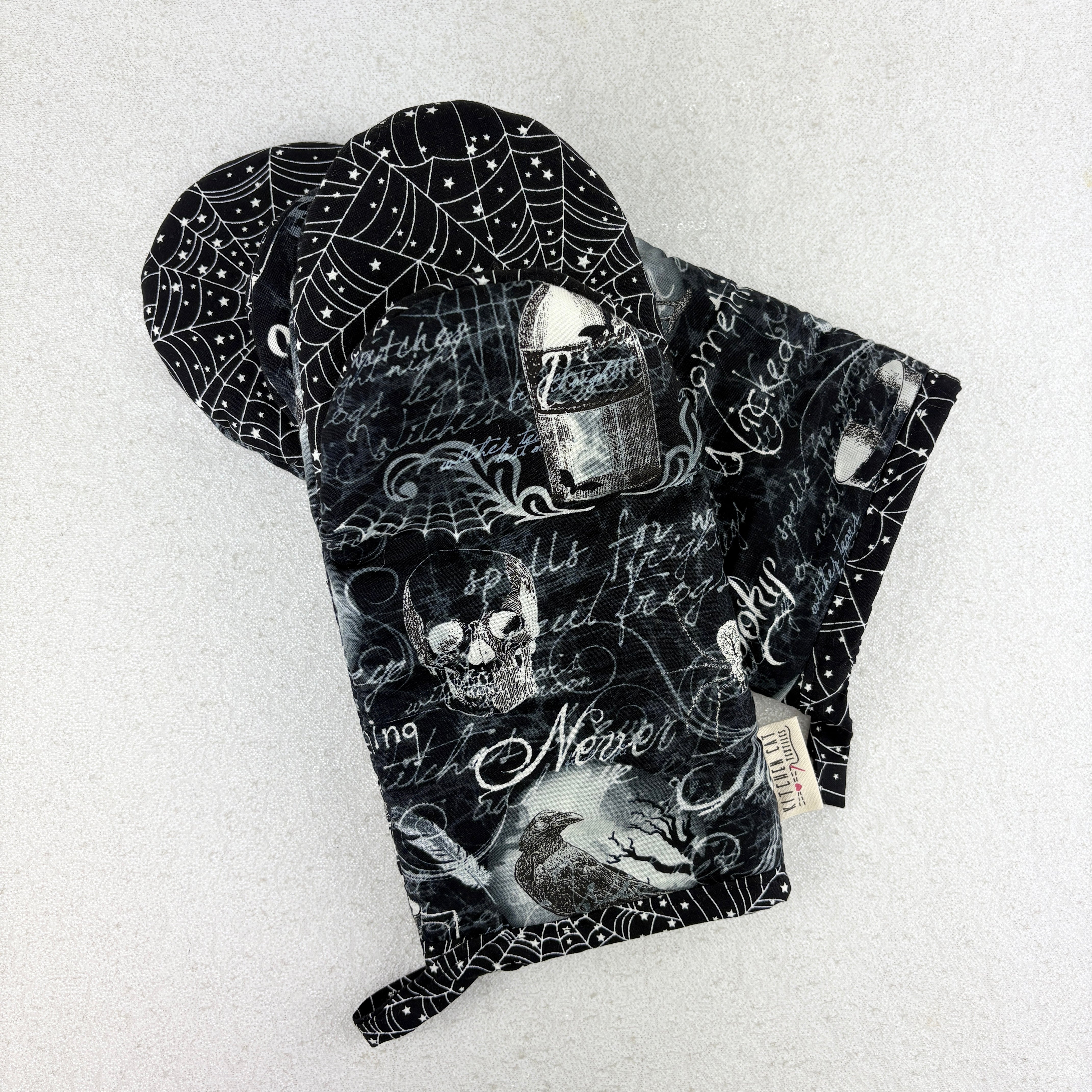 oven mitts with skulls and spooky things