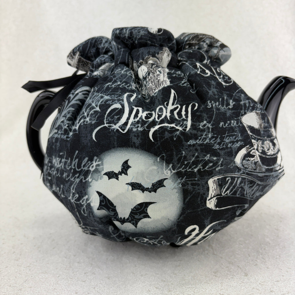 Decorative Halloween teapot with black and white design on a white background