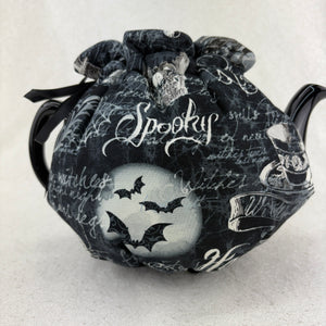 Decorative Halloween teapot with black and white design on a white background