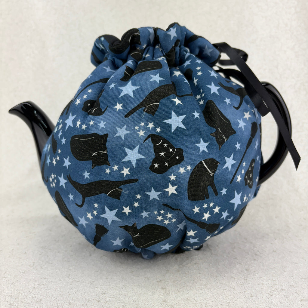 tea cosy with black cats and witch hats