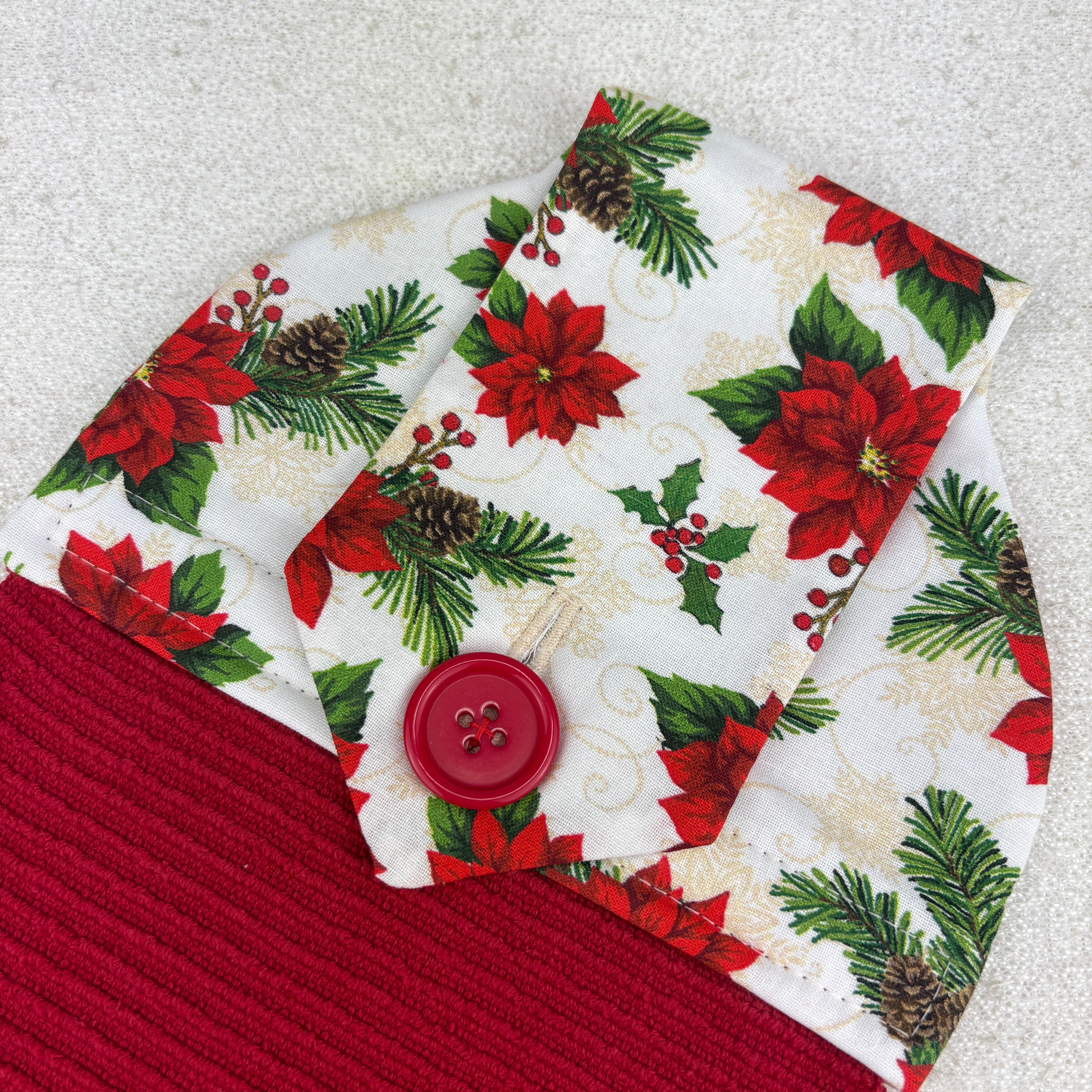 kitchen towel with pattern of poinsettias and holly