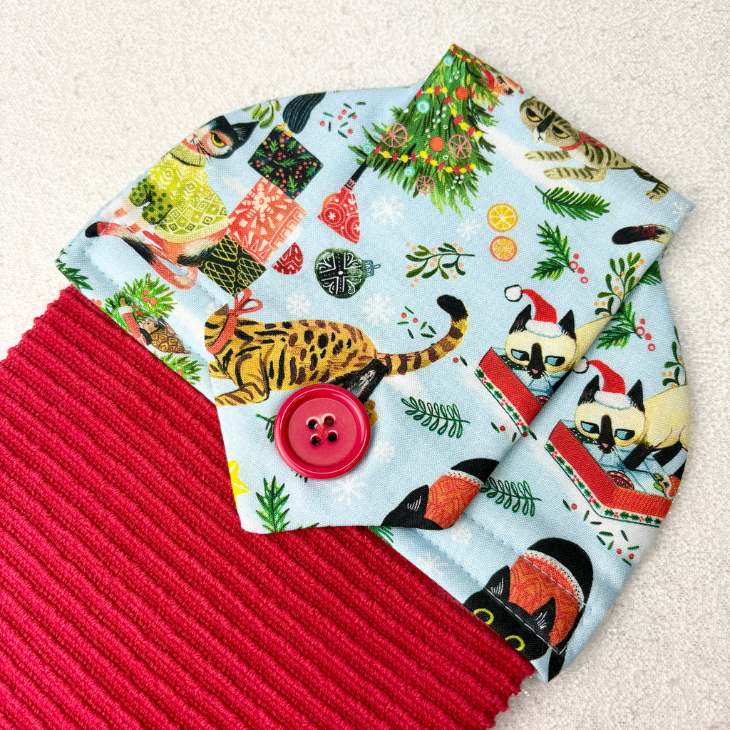 kitchen towel with festive cats and christmas decorations
